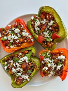 Lentil- and quinoa-stuffed peppers on a plate.