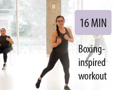 women boxing instructor leading exercise with a following sitting student in room