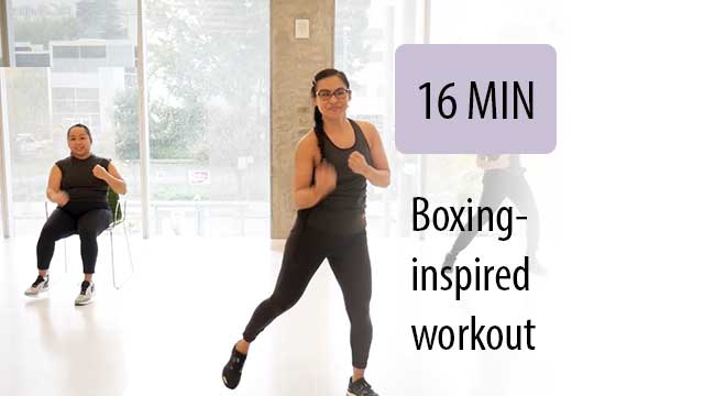 women boxing instructor leading exercise with a following sitting student in room