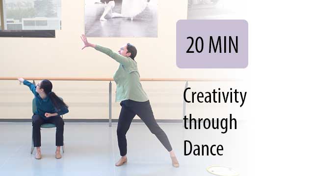 creative dance instructor leading seated student in gym