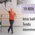 ballet instructor leading seated student in gym to tendu movements