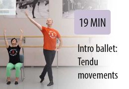 ballet instructor leading seated student in gym to tendu movements