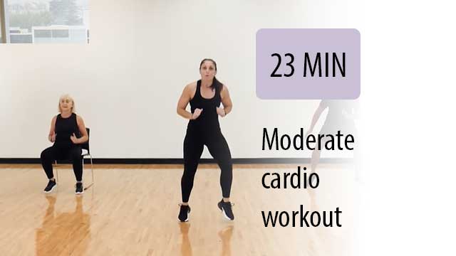 instructor leading a sitting student in cardio workout