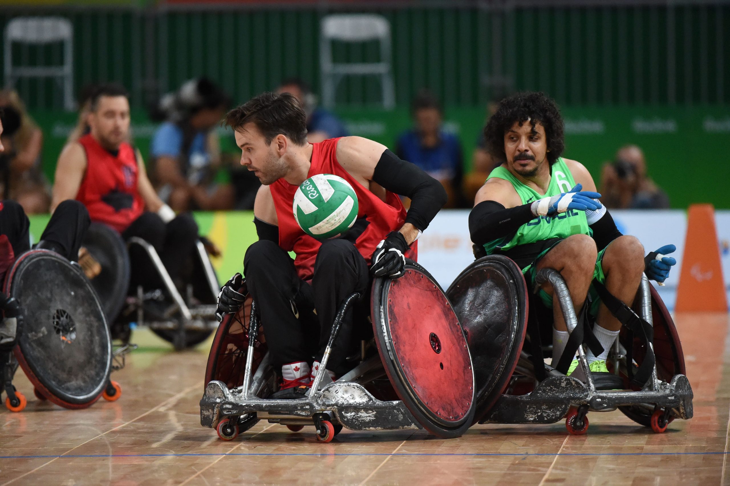 A group of men playing wheelchair rugby. 