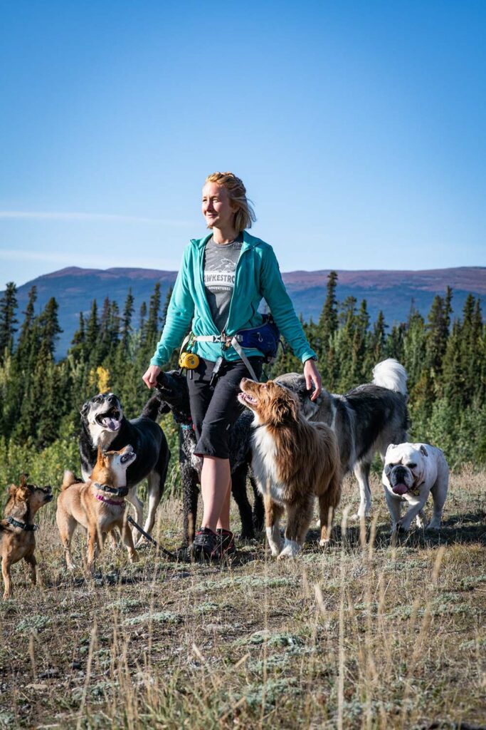 Britt Pearson posing with her nine dogs