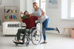 men in a wheelchair dancing with a woman