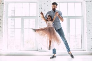 father and young daughter dancing