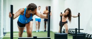 women pushing weights in fitness centre