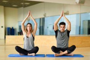 A woman and man doing yoga - one of many great active date ideas. 