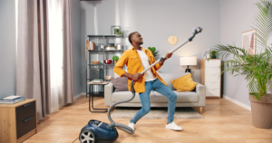 guy with a vacuum cleaner playing air guitar