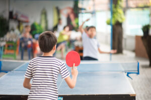 Kids playing table tennis - a great way to exercise at home. 