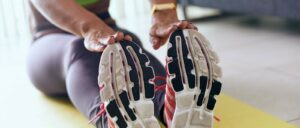 A person stretching by touching her toes. She has figured out how to find time to exercise.