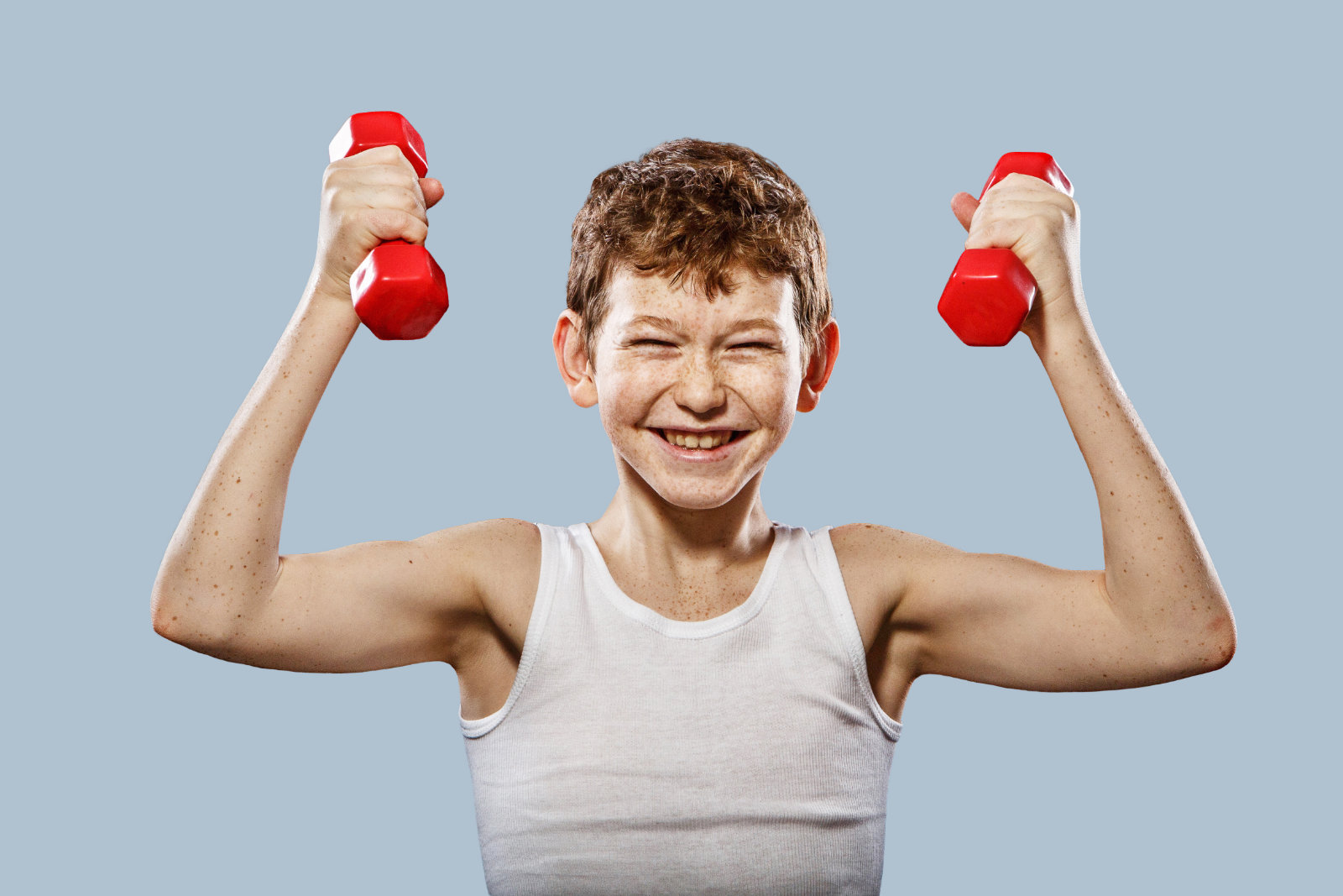 Boy exercising with dumbells