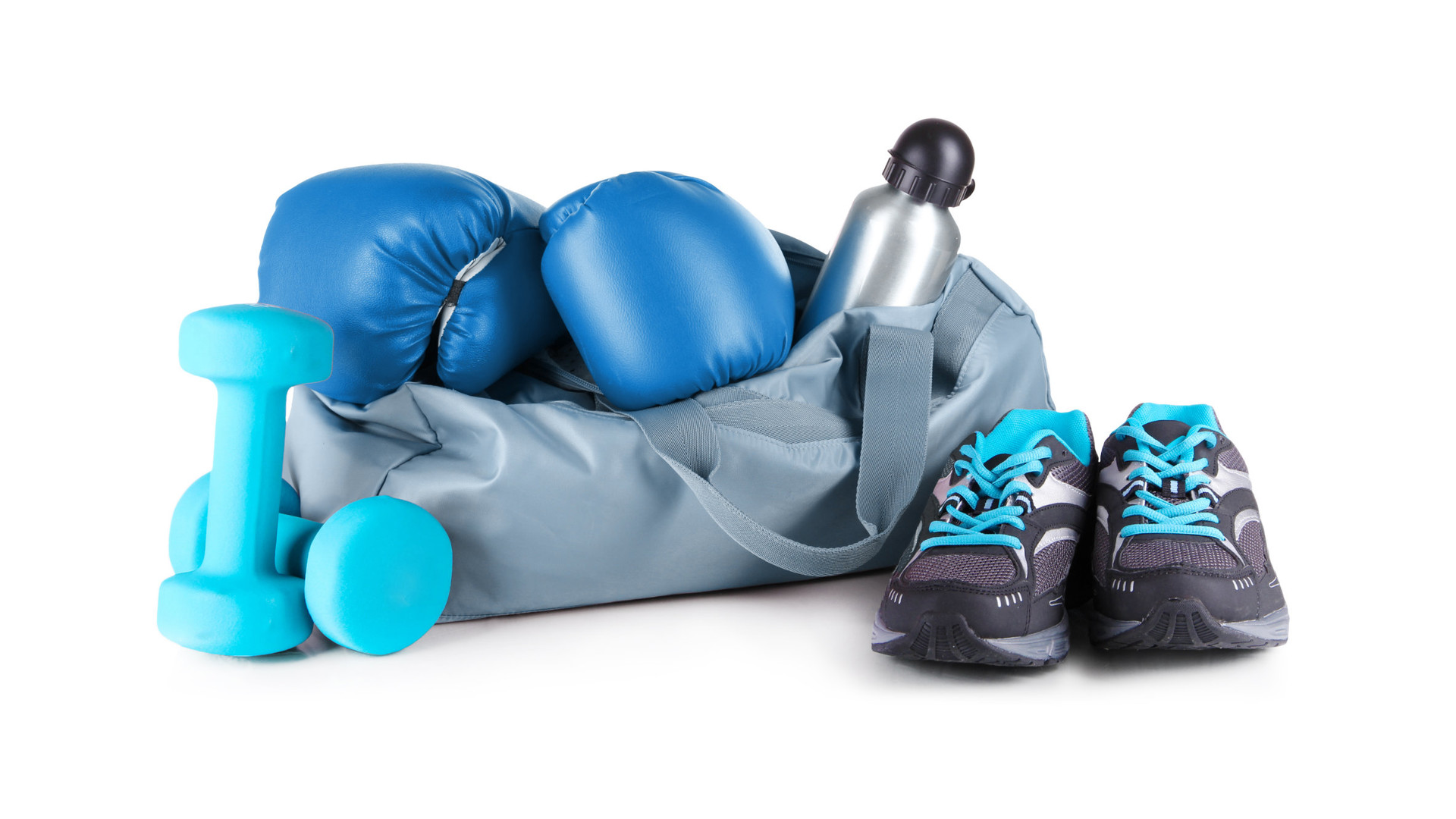 A gym bag surrounded by boxing gloves, dumbbells and sneakers