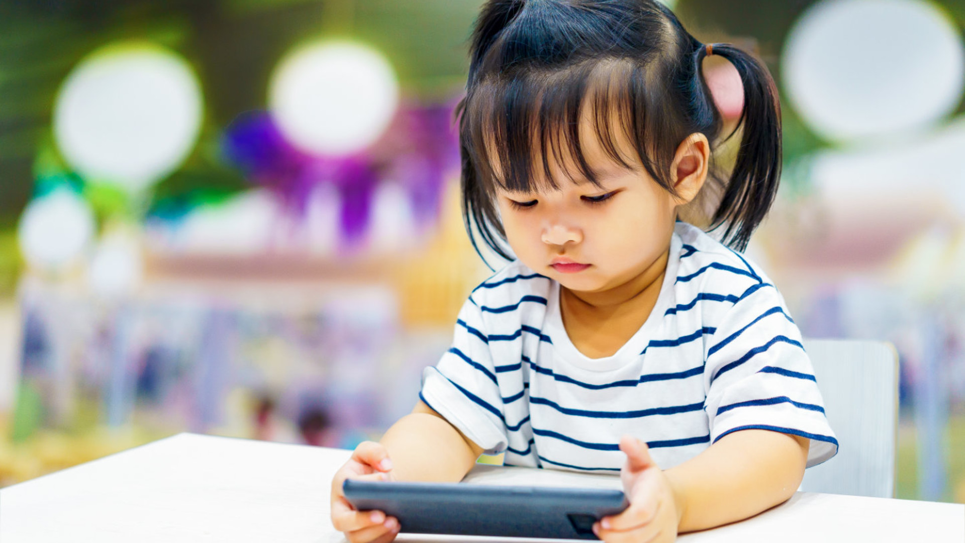 Little girl holding a smartphone