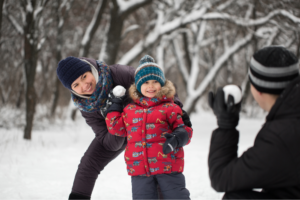 A family having a snowball fight. 