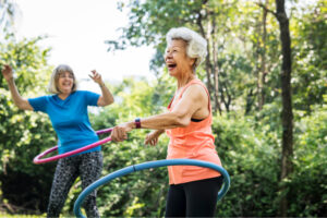 older women playing with hula hula