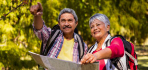 A couple looking at a map while hiking.