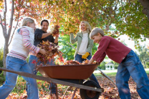 family playing with autumn leaves