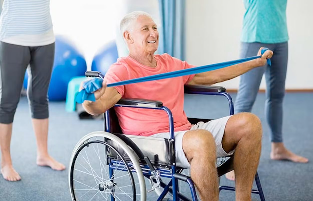 Man with a band exercising on a wheelchair