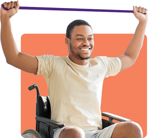 A smiling man using an exercise band over his head while seated in a wheelchair