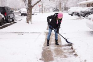 woman scooping snow