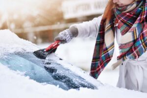 woman scraping snow