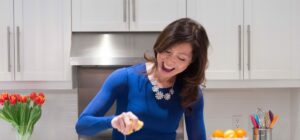 Sue Mah cooking a meal in a kitchen.