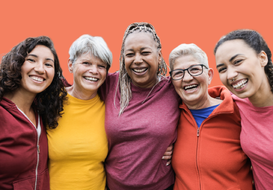 A group of active women smiling and embracing A group of active women smiling and embracing