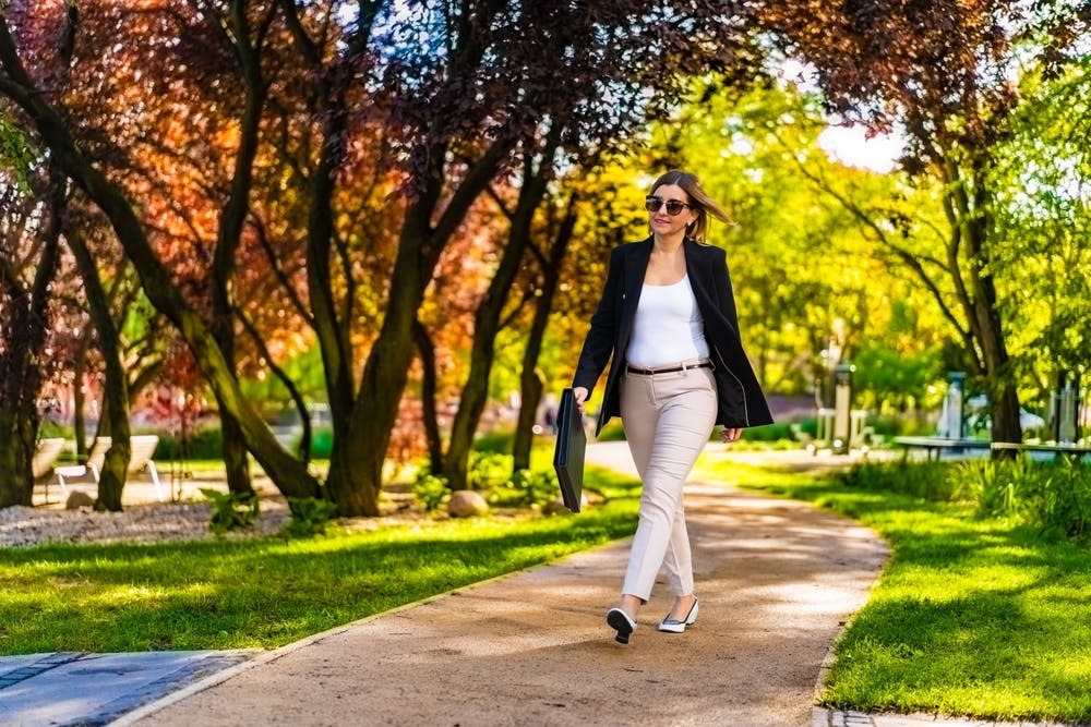 Woman walking outdoors with a office outfit