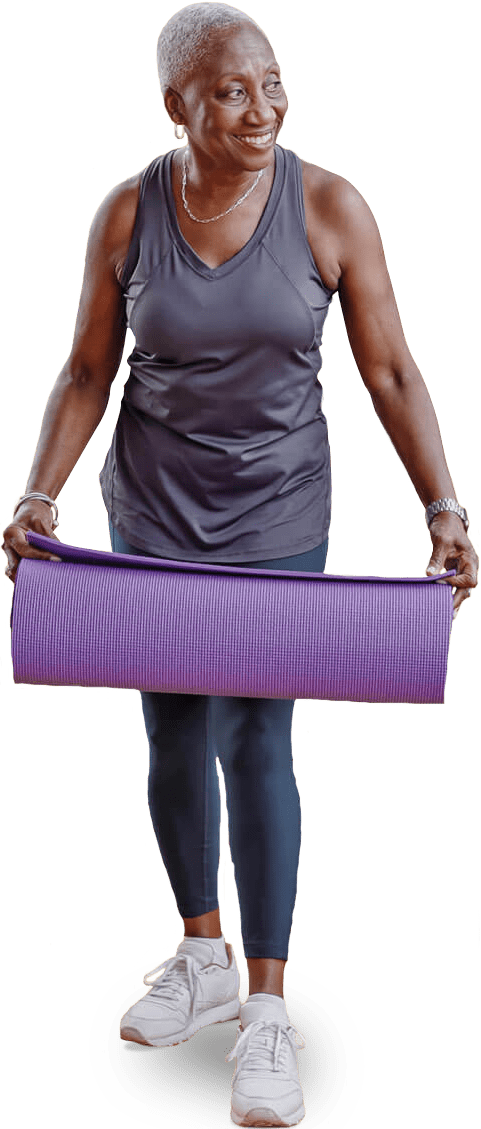 Senior lady holding a purple yoga mat Senior lady holding a purple yoga mat