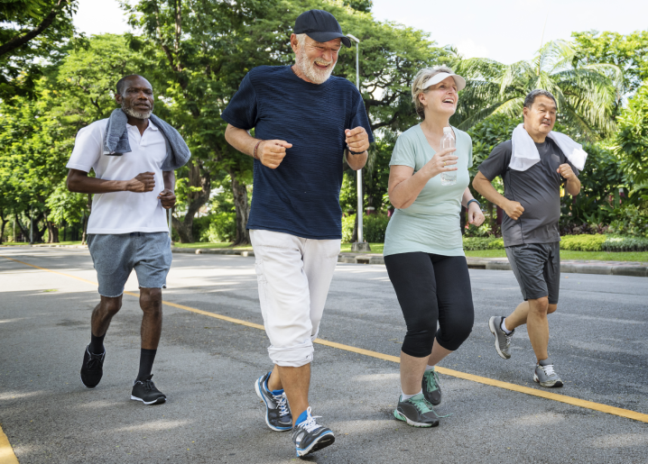 Diverse group of seniors jogging together