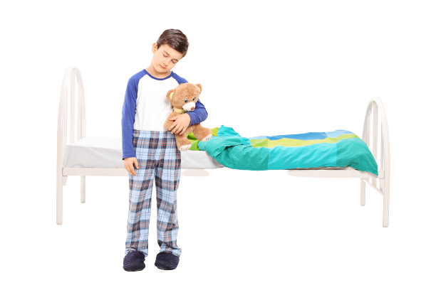 sleepy kid on pajamas holding his teddy bear in front his bed sleepy kid on pajamas holding his teddy bear in front his bed