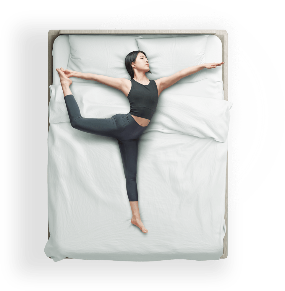 An image of a woman in yoga pose on a bed