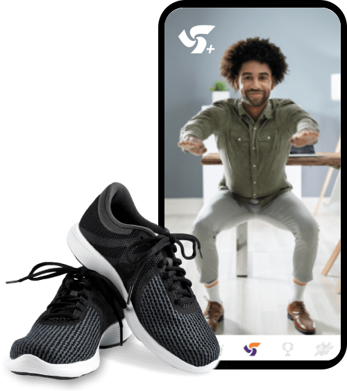 A pair of black-and-white running shoes beside a smartphone displaying  a man doing a squat