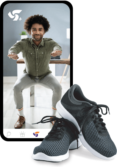 A pair of black-and-white running shoes beside a smartphone displaying a photo of a man doing a squat 