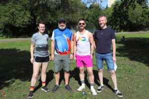 Cat Goodfellow (far left) standing with three other members of the Ottawa Frontrunners, a running and walking club that provides opportunities for physical activity for 2SLGBTQQIA+ people and friends.
