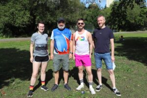 Cat Goodfellow (far left) standing with three other members of the Ottawa Frontrunners, a running and walking club that provides opportunities for physical activity for 2SLGBTQQIA+ people and friends.