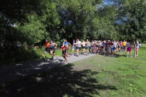 : 2022 National Capital Pride Run participants running on a park trail