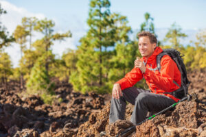 A young man eating a candy bar outdoor