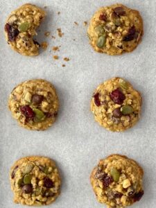Six trail mix cookies on the baking paper
