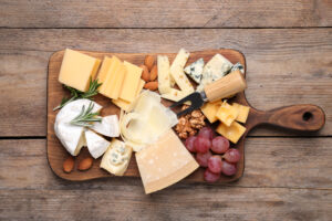 fruit and cheese on a woodboard