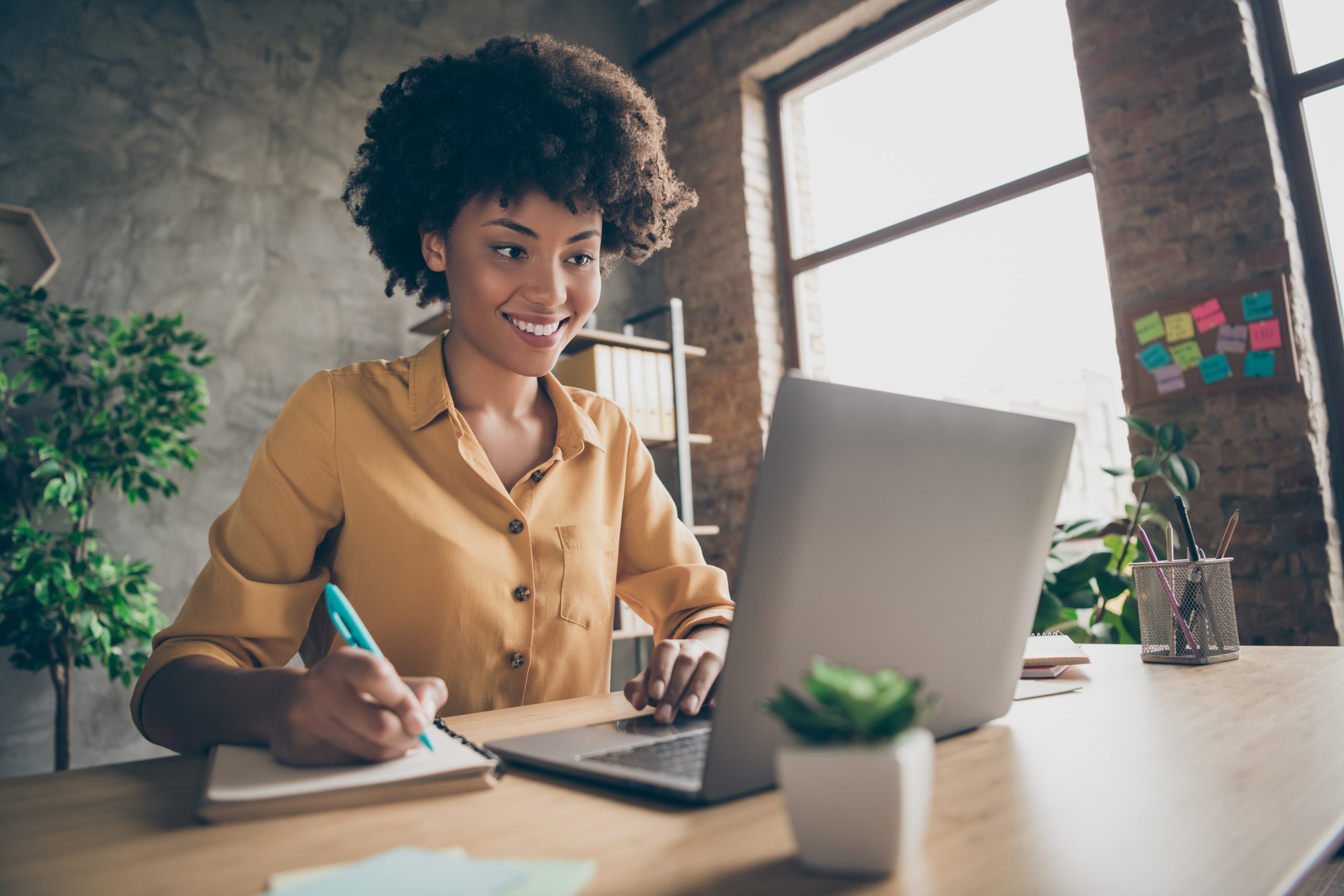 a woman working on a laptop in an office