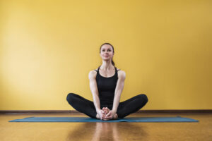 A woman doing the butterfly exercise, one of many great exercises for period cramps. 