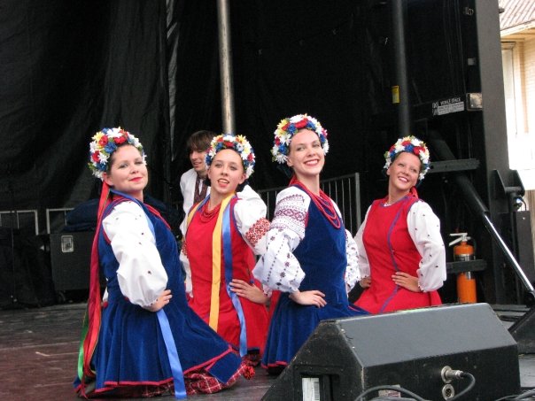 Stephanie Ehmke standing on a stage with three other Ukrainian dancers.