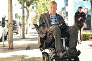 Sam Sullivan on a city sidewalk.