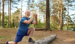 A man doing lunges in a park.