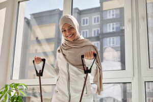 A smiling woman working out with resistance bands.