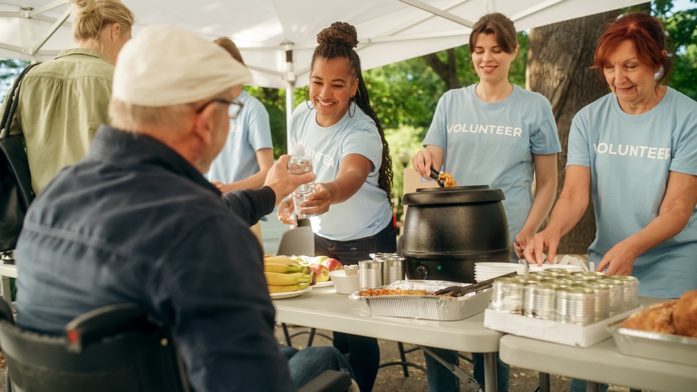 A group of people serving food at a food bank.