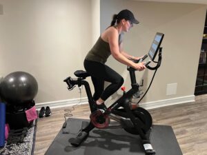 ParticipACTION employee Alison Carruthers exercising on a Peloton stationary bike. 